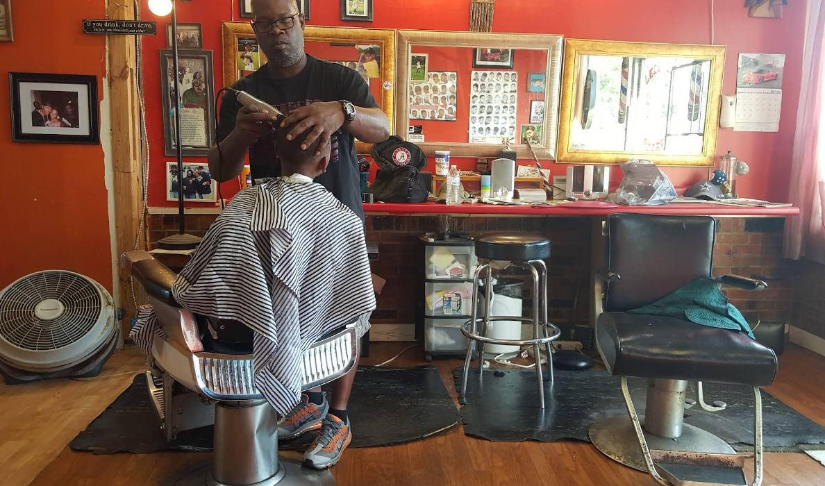 Mr. Jerome cutting hair at Legends Barber Shop